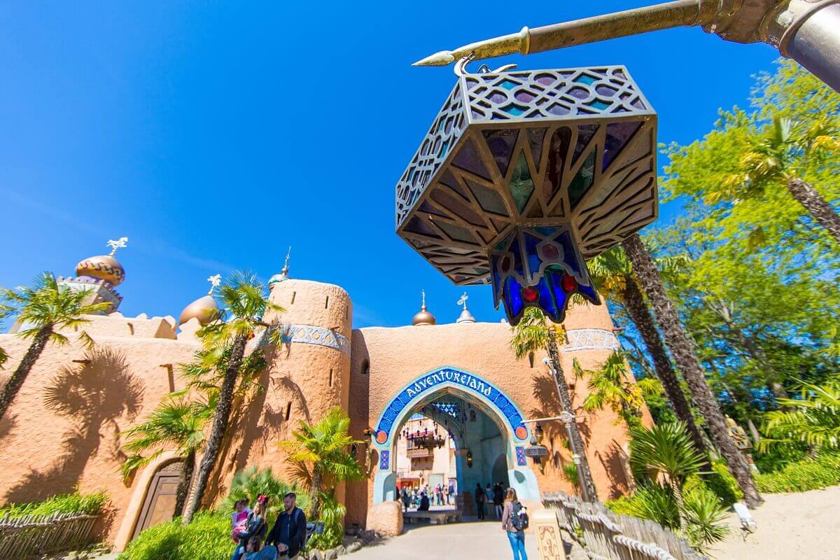 Oriental lamp and entrance to Adventureland View from below of a detailed oriental lamp in front of the entrance to Adventureland