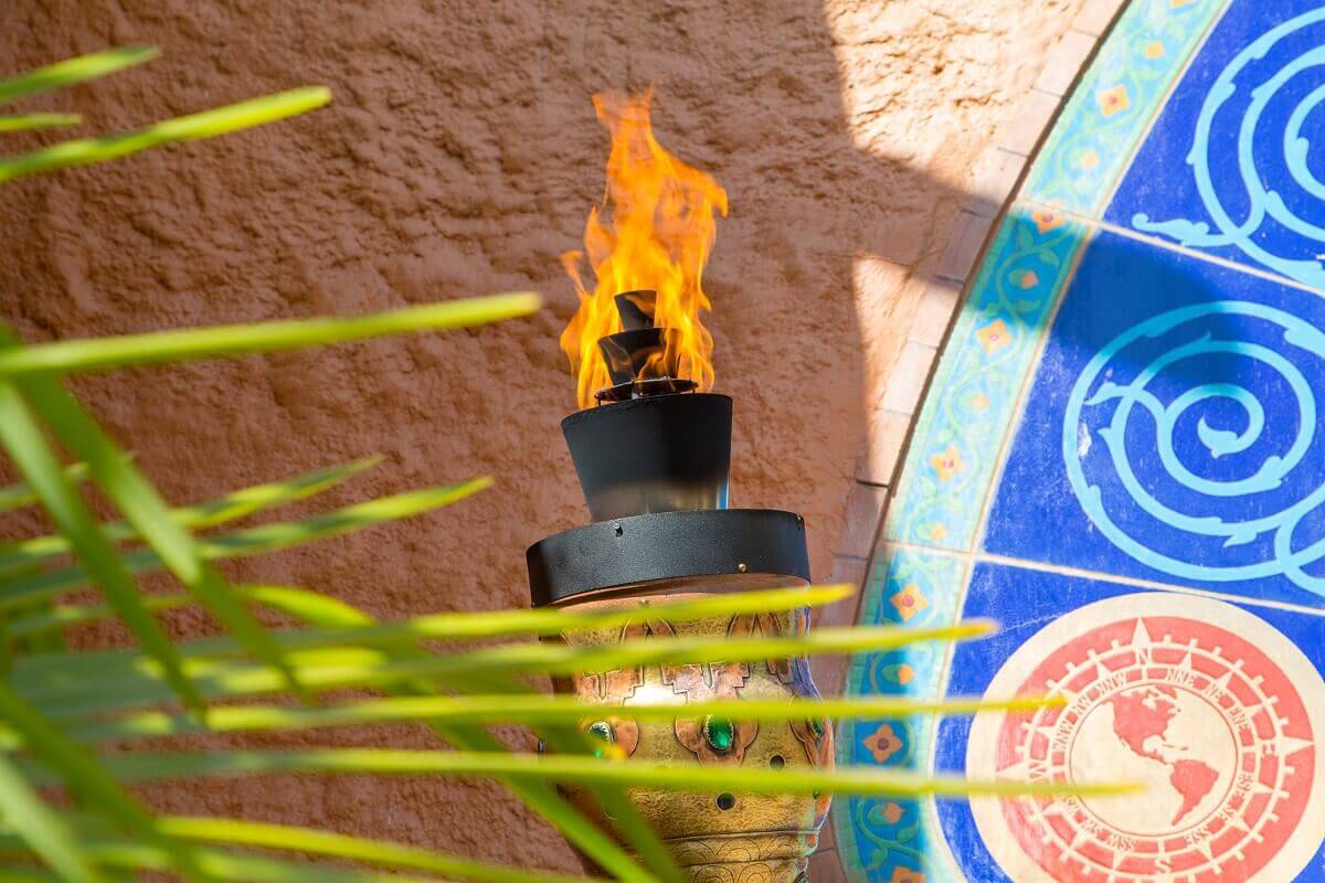 Torch at the gate to Adventureland a flaming torch at the oriental decorated gate to Adventureland