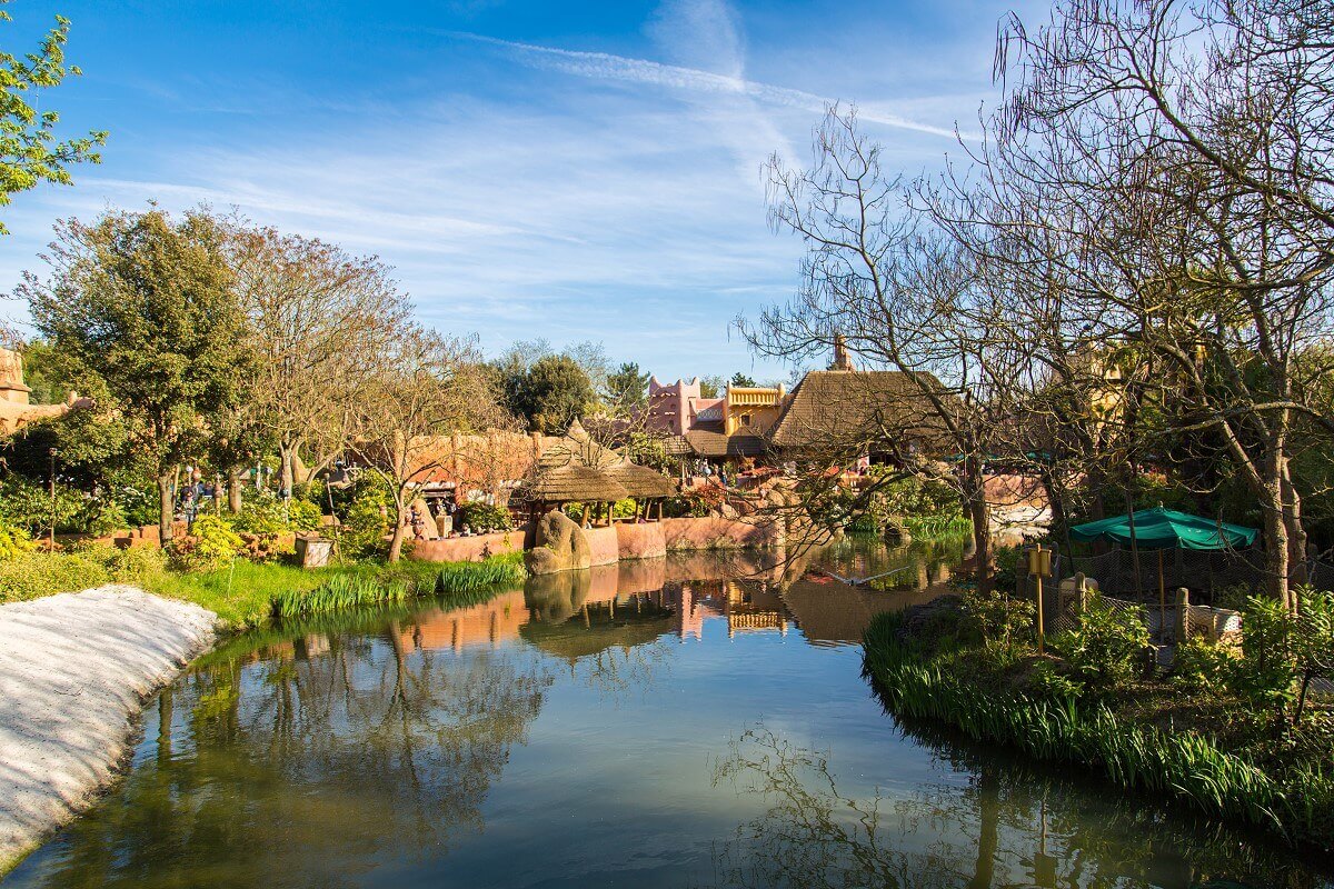 Water in Adventureland View over a body of water in Adventureland to the Africa area and the Hakuna Matata restaurant