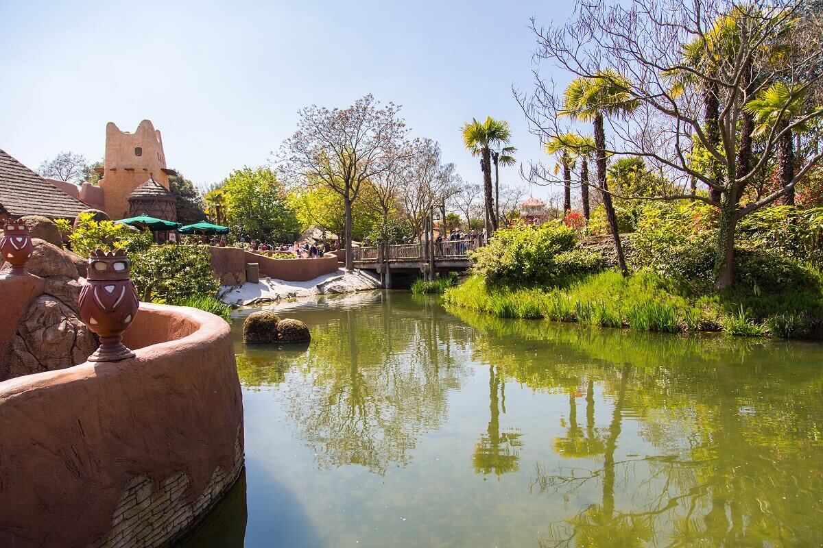 Shallow waters in Adventureland View of a shallow body of water in the African area and the outdoor area of the Hakuna Matata Restaurant