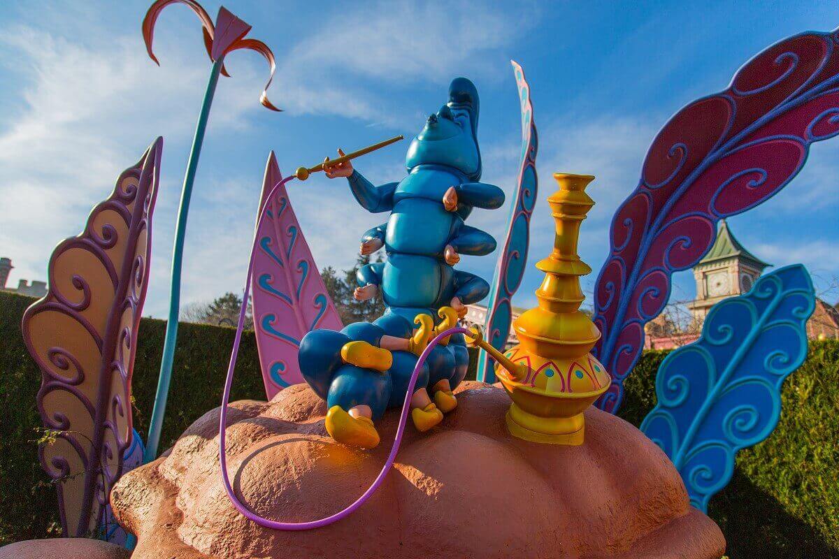 A hookah smoking caterpillar the mysterious blue caterpillar from Alice in Wonderland sits on a large mushroom and smokes a water pipe
