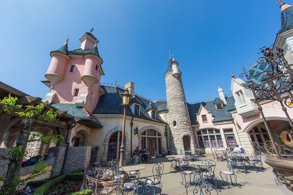 Exterior view of the Auberge de Cendrillon View of the courtyard and the pastel-coloured building of the Auberge in Fantasyland