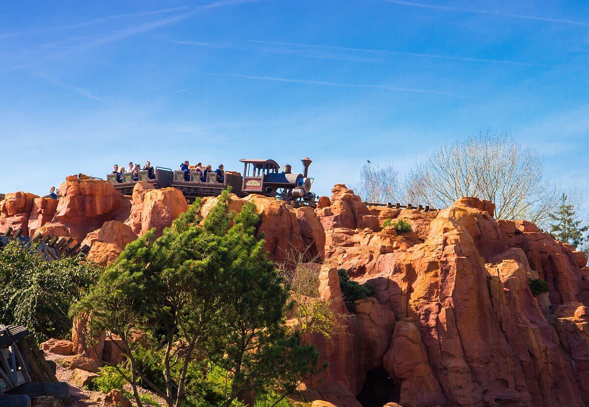 The mine train at Big Thunder Mountain A Big Thunder Mountain roller coaster train drive through the rocky hills