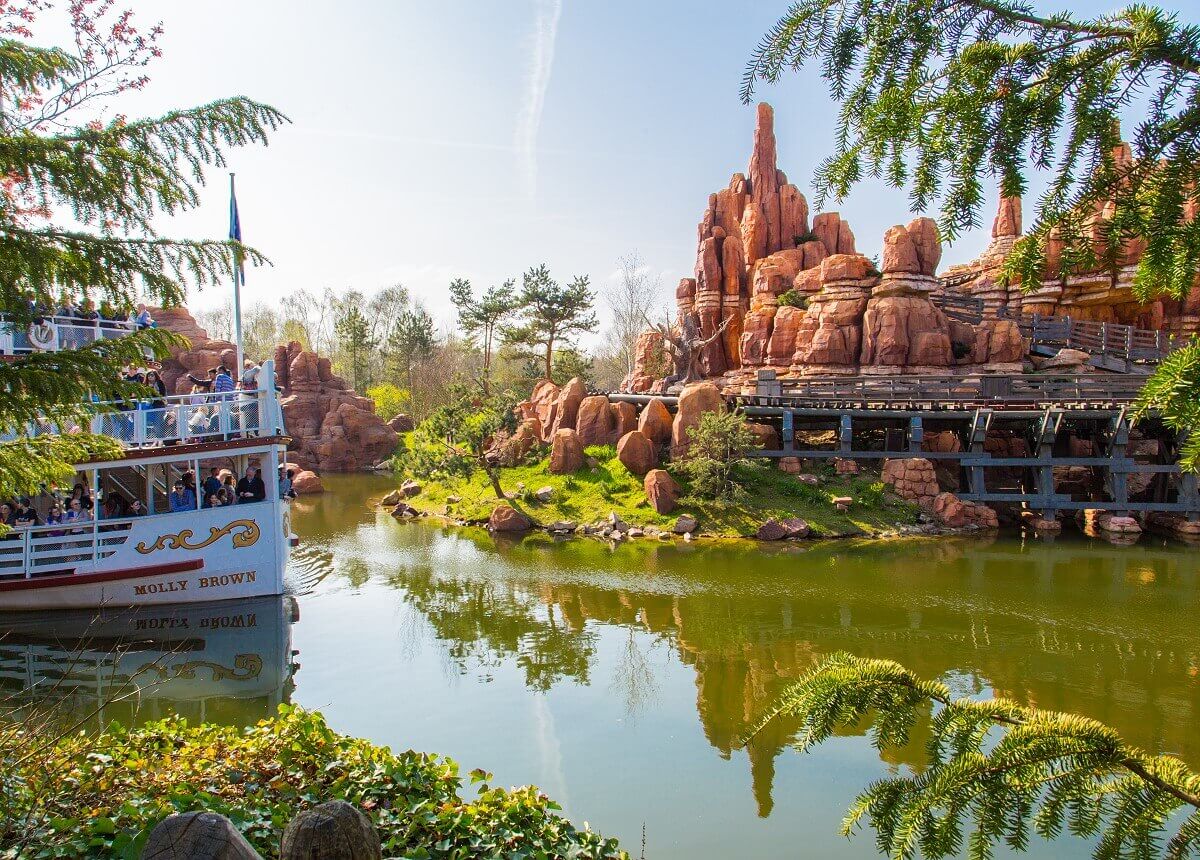 View of Big Thunder Mountain Big Thunder Mountain and the steamboat Molly Brown in the middle of the Rivers of the Far East