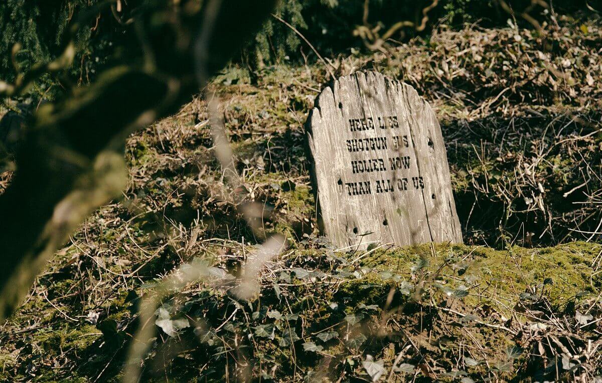 Single grave at Boot Hill On a hill at the cemetery near Phantom Manor the plain grave of Shotgun Gus is visible