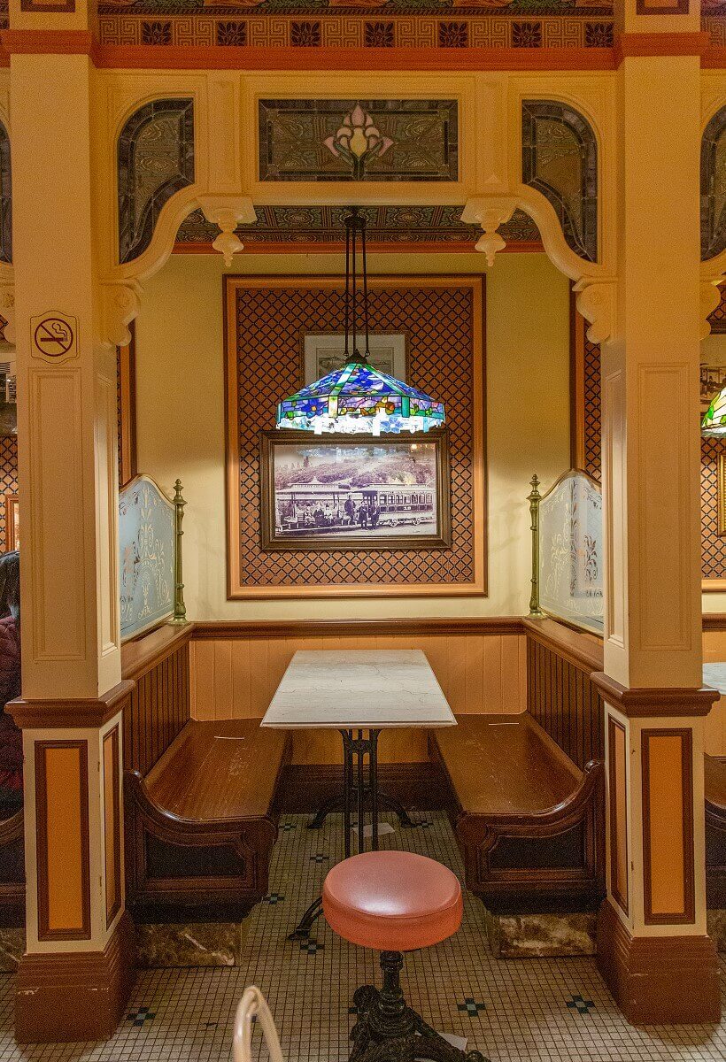 Restaurant Booth One of the restaurant booths in the Cable Car Bakeshop, with a historic black-and-white photograph on the wall and a blue-and-green Tiffany-style hanging lamp