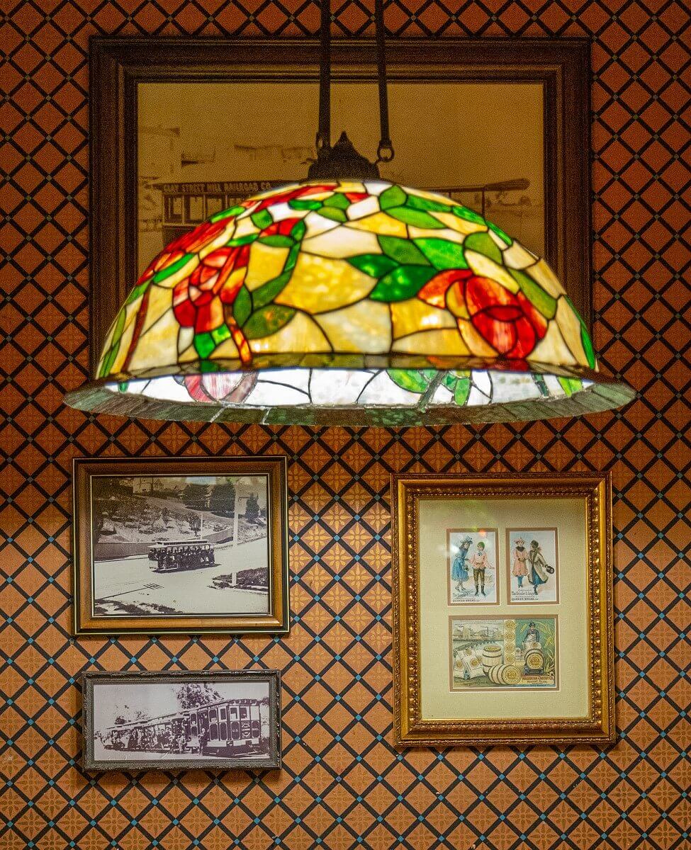 Detail of a hanging lamp in Tiffany style Detail of a hanging lamp in Tiffany style. The lamp has a round shade and the individual segments represent roses and their leaves