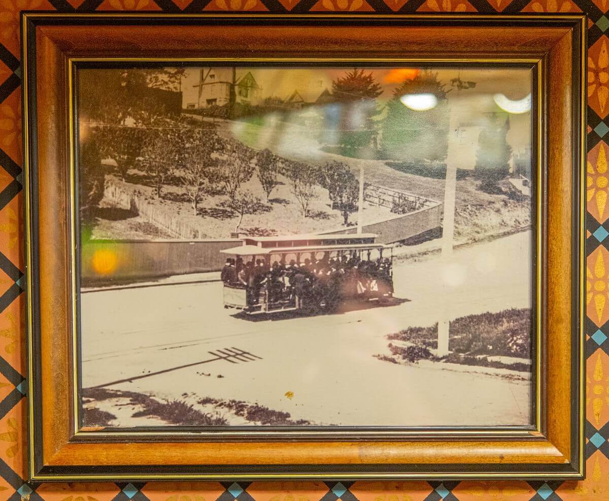 Historical photograph of a cable car Historic photograph of a cable car full of passengers just passing through a dip