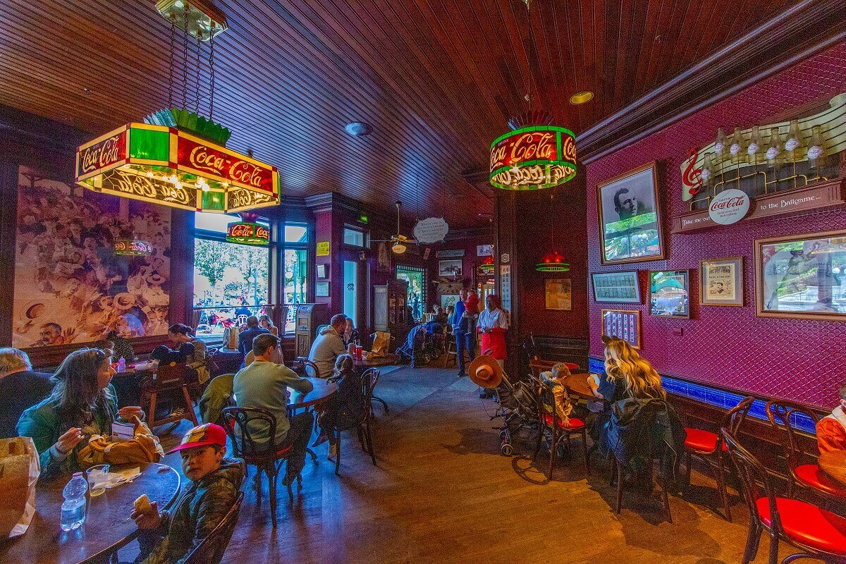 The guest room of Casey's Corner The dining room of Casey's Corner with red wallpaper, lots of baseball memorabilia on the walls and in display cases, and lamps, Tiffany-style, advertising Coca Cola