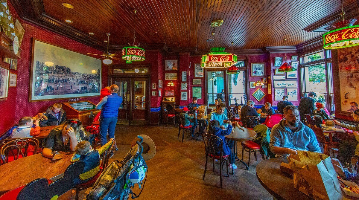 The guest room seen from the bar area The guest room as seen from the counter area. The room is dominated by a huge historical picture of a baseball game hanging above an antique baseball slot machine