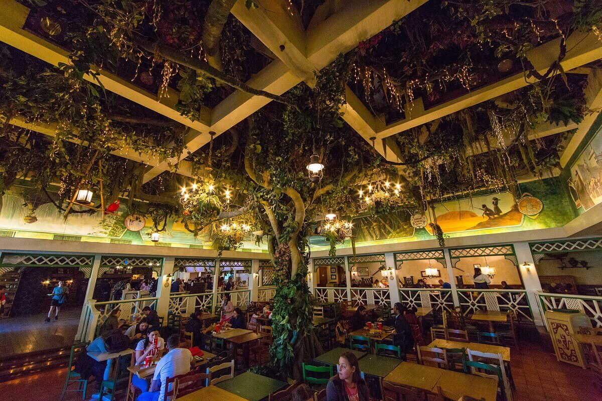 Interior view of the restaurant View into the large interior of the Colonel Hathis with a tree in the middle and a ceiling overgrown with plants