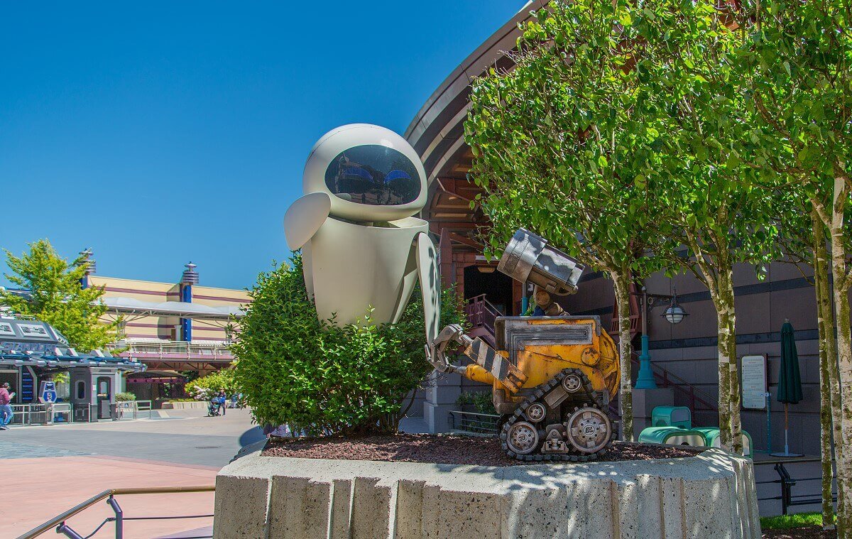 Wall-E and Eve on a stone pedestal stands a figure of Wall-E and Eve