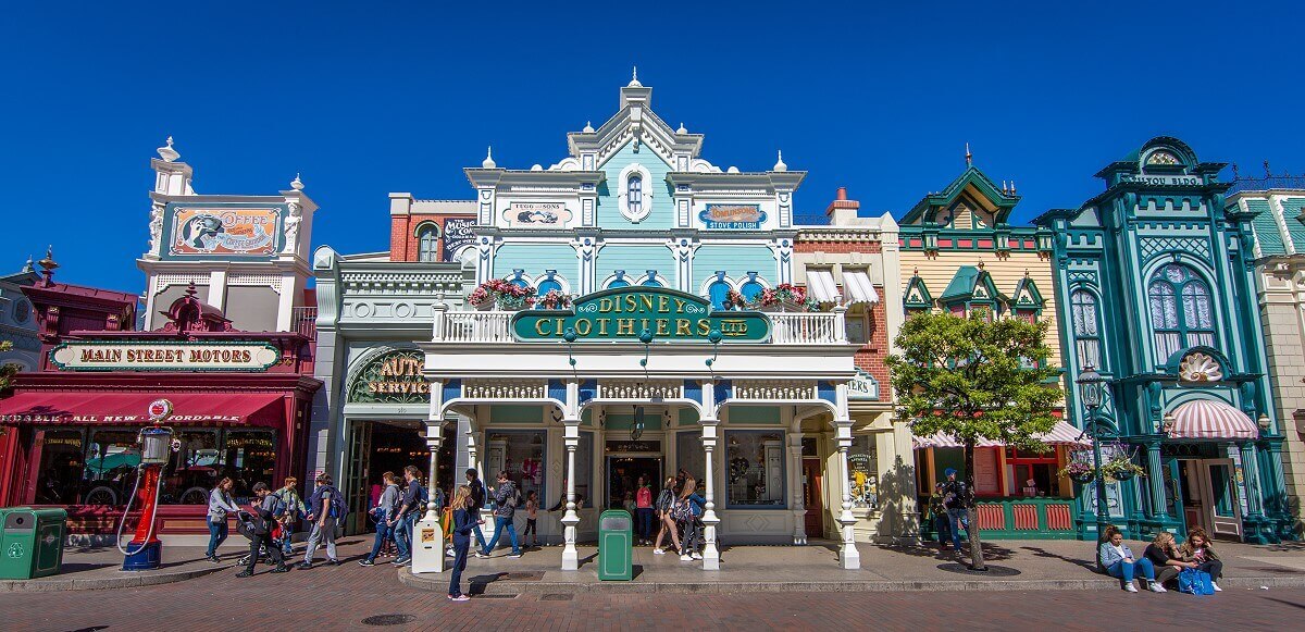 Disney Clothiers Building The Disney Clothiers building is nestled between Main Street Motors and Candy Palace. It has a white wooden porch and is paneled with turquoise painted wood