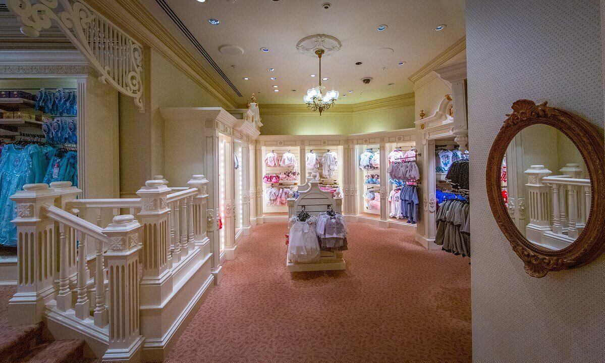 Baby and toddler department Baby and toddler department. On the left you can see three steps to the department. The whole area has a lime green wallpaper and white furniture