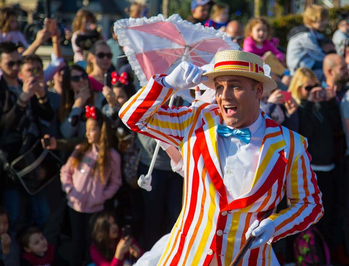 Bert Bert is dancing at Disney Stars on Parade. He grabs his dog with his right hand