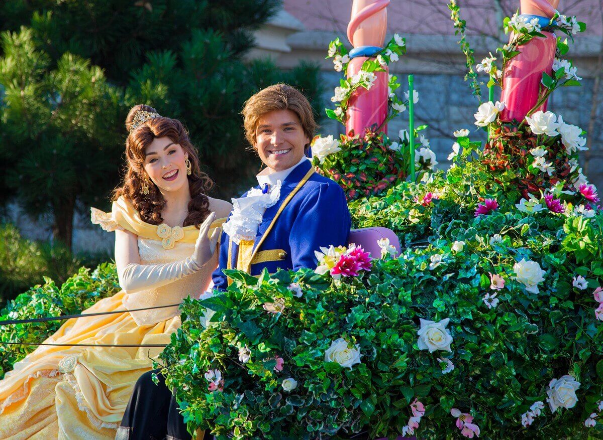 Belle and Adam Belle and Adam sit in their carriage decorated with lots of greenery and flowers