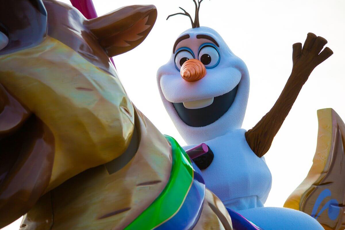 Snowman Olaf waves Snowman Olaf rides Sven while laughing and waving eagerly