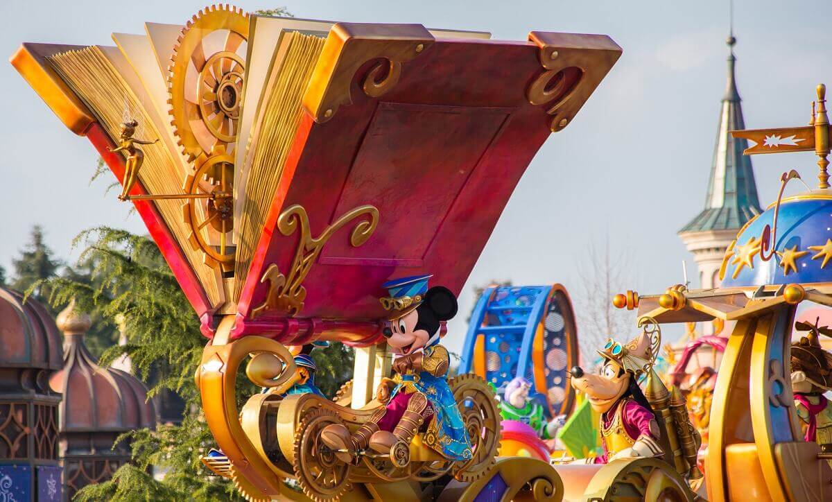 Storybook Parade Float A giant red storybook with gold trim dominates Mickey Mouse's parade float