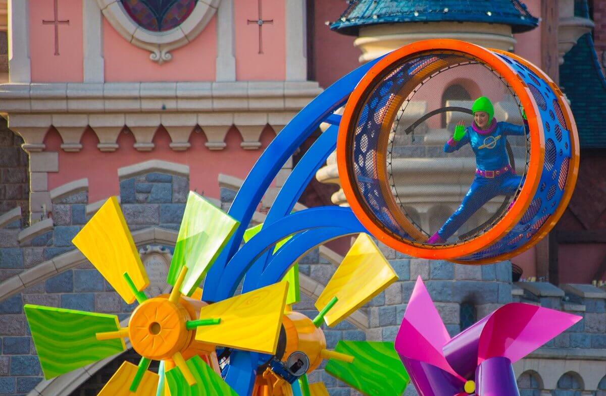 Acrobatic dancer at the parade An actrobatin in a large wheel attached to the toy tower of the Toy Story parade float
