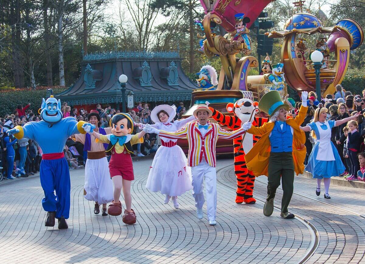 Dancing Disney characters at the parade Disney Stars on Parade features Genie, Pinocchio Bert and the Mad Hatter dancing hand in hand, followed by Aladdin, Mary Poppins, Tigger and Alice in Wonderland.