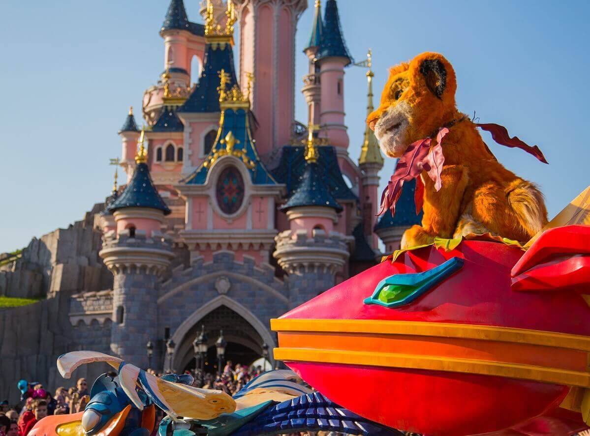 Simba in front of Sleeping Beauty Castle The parade float on which Simba is sitting drives in front of Sleeping Beauty's castle
