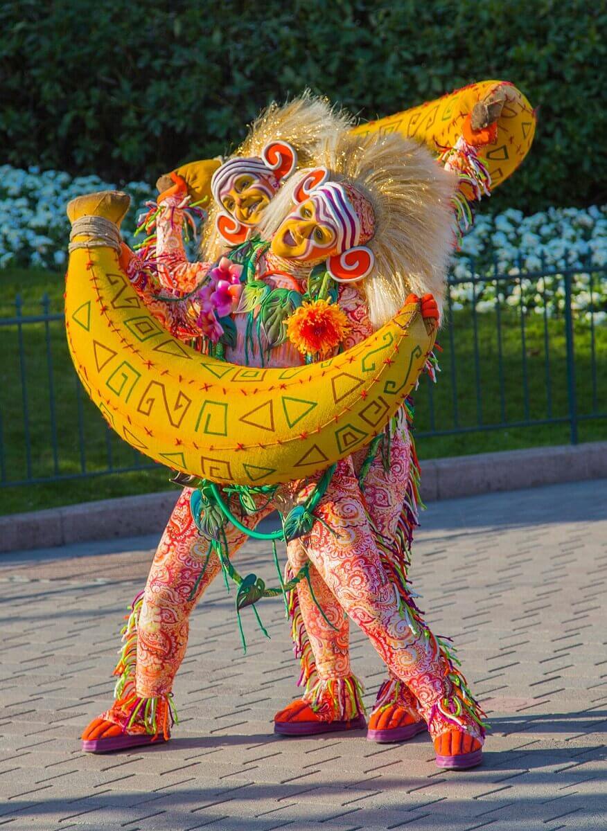 Two dancers with bananas Two colorfully dressed dancers dance on the parade route holding huge bananas in their hands