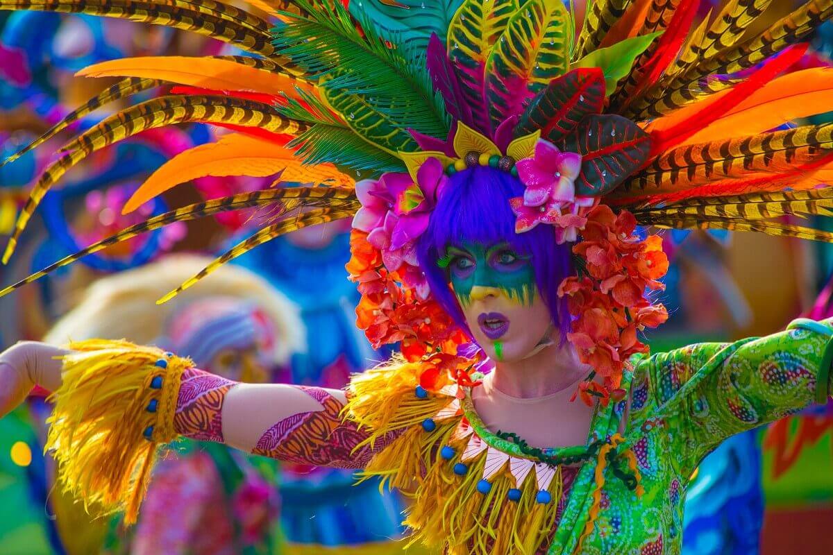 Dancing plant at the parade A colorful plant dances along at Disney Stars on Parade - A dancer wears a colorful costume of feathers, flowers and leaves