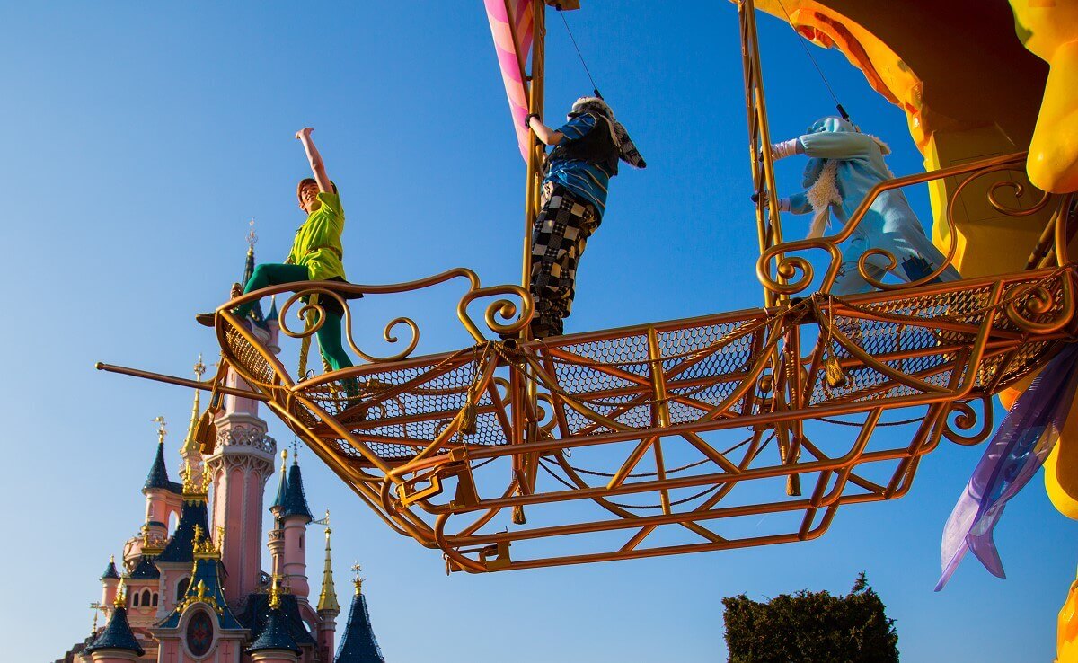 Peter Pan flies Peter Pan in his flying pirate ship in front of Sleeping Beauty's castle