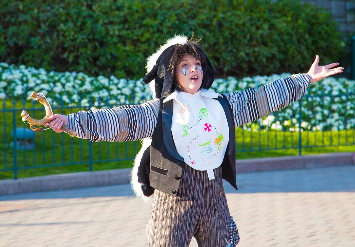 Dancer in animal costume A dancer at Disney Stars on Parade with her arms stretched wide to the side and wearing an animal costume