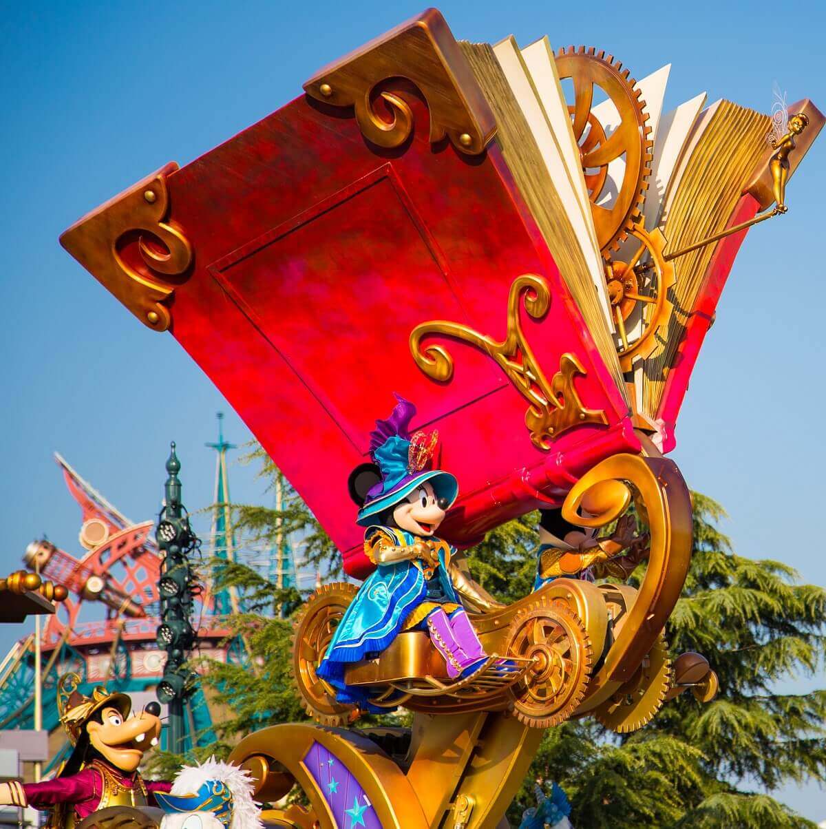 Parade float with storybook A giant storybook sits high atop the parade float. Minnie Mouse and Goofy are also on this parade float