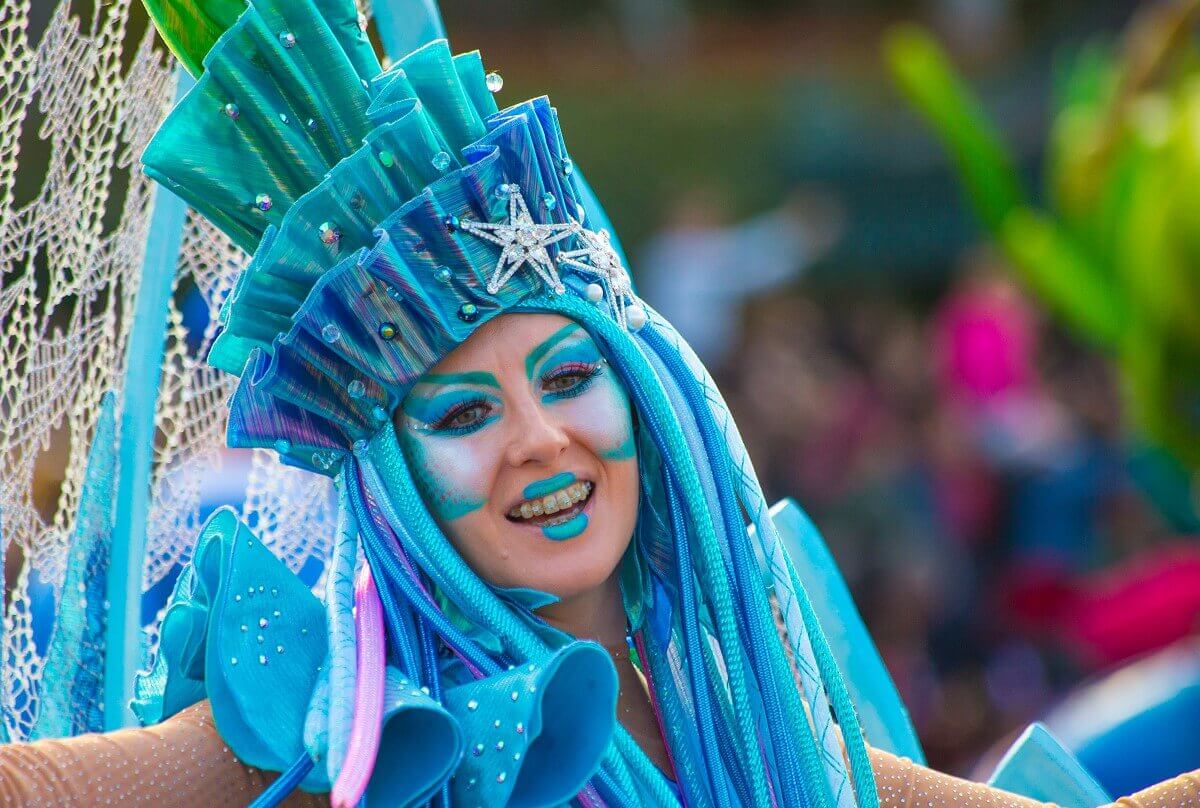 Water creature dancer Frontal shot of a parade dancer in a underwater beast suit with blue hair in which there are pearls and starfishes
