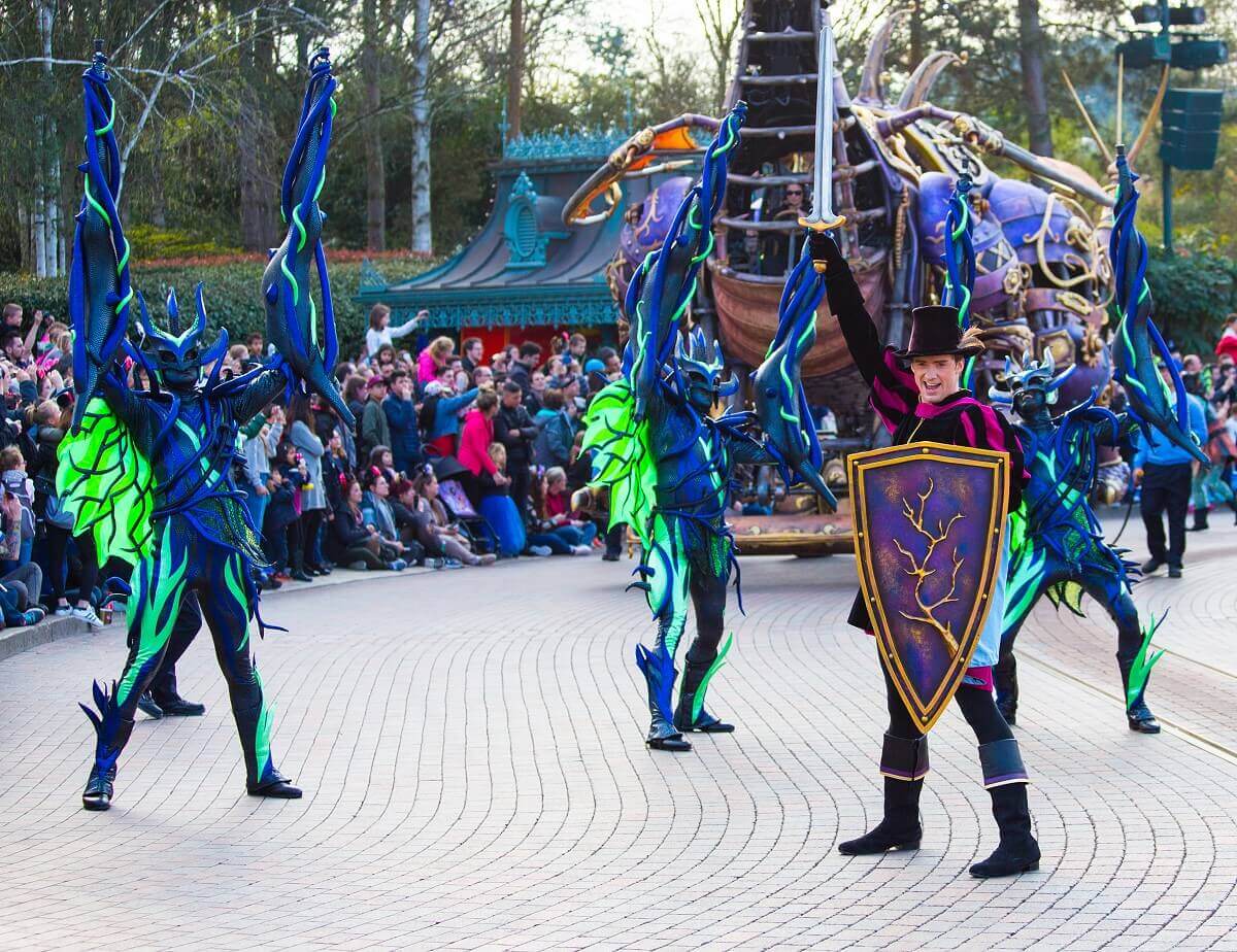 Prince Philip in victory pose Prince Philip holds his sword in victory pose in the air, behind him some thorny vines and the dragon can be seen