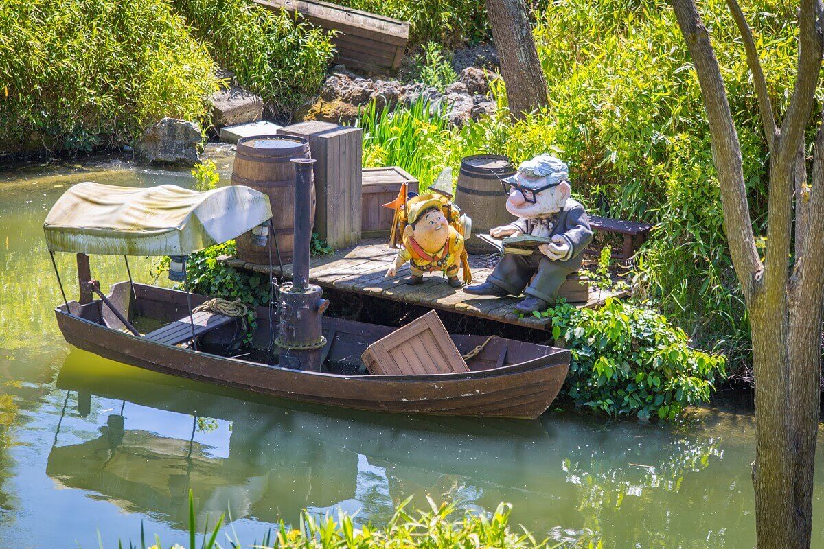 Carl and Russell at a small boat dock Carl and Russell from Pixar's Upstairs are seen at a small boat dock at Adventureland Lake