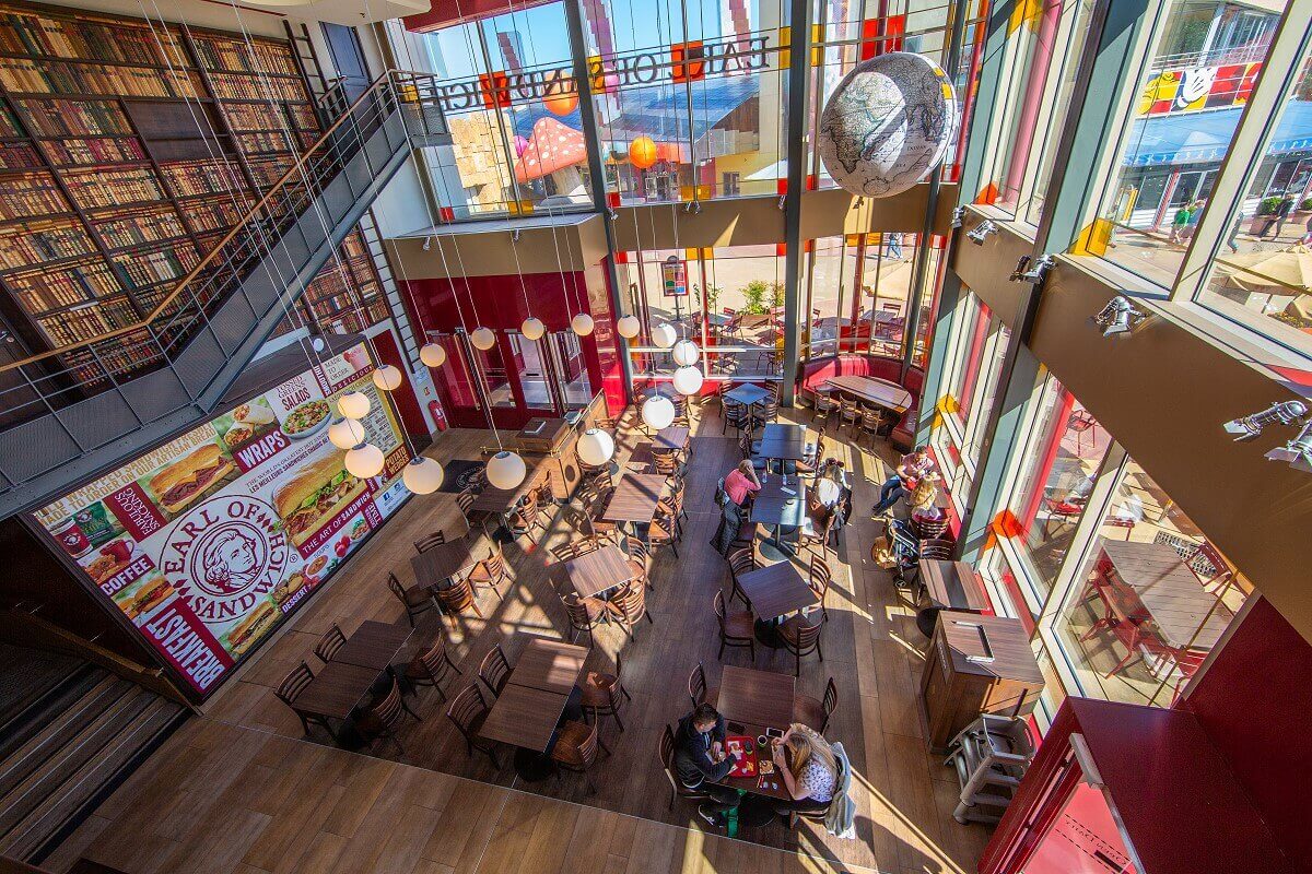 View from the upper floor to the ground floor of the guest room View from the upper floor to the ground floor of the guest room. This is to be seen in a long shot. In the background a large globe hanging from the ceiling, on the left the wall designed like a library.