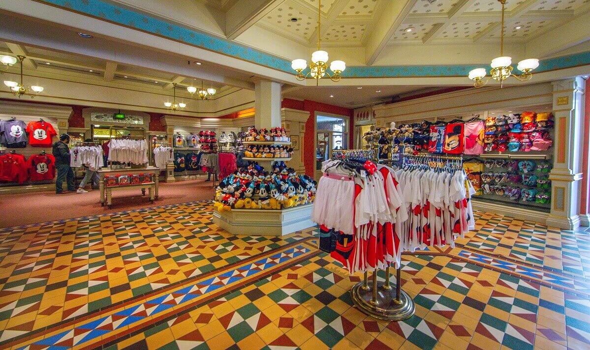 long shot of a salesroom Long shot of a salesroom with clothes on racks in the foreground and shelves in the background as well as a large shelf with stuffed animals in the center of the room.