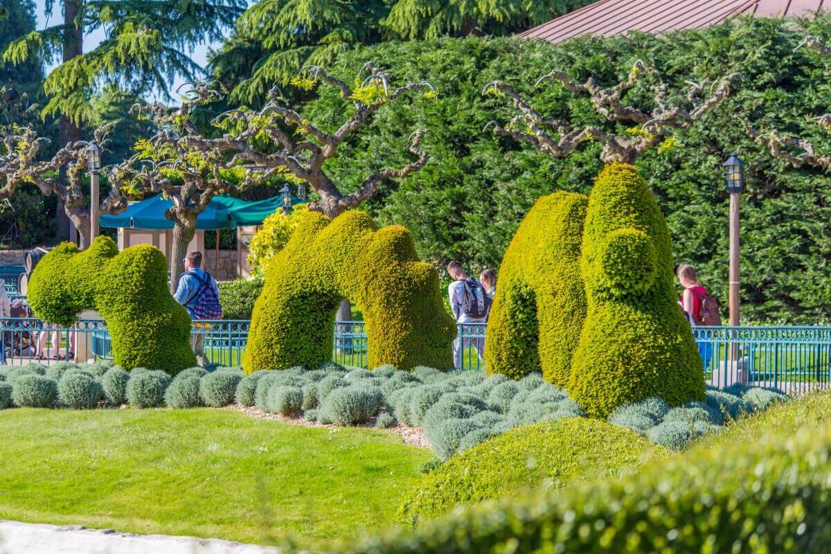 Plant figure in Fantasyland on a lawn stands a large figure of a water snake overgrown with plants