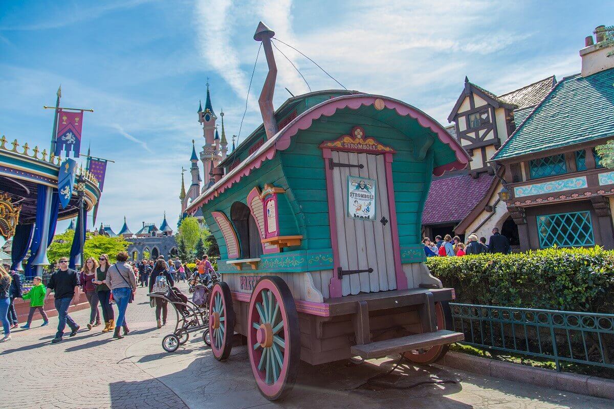 Kiosk in Fantasyland a small kiosk in the shape of a circus wagon with a poster of the Pinocchio villain Stromboli stands on a square in Fantasyland