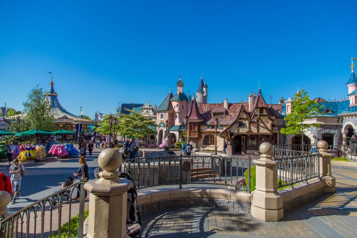 Way from the castle to Fantasyland a few steps lead down from a small platform at the castle into Fantasyland