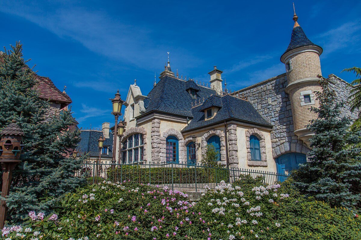 The Auberge de Cendrillon View past plants to the elegant building of the Auberge de Cendrillon