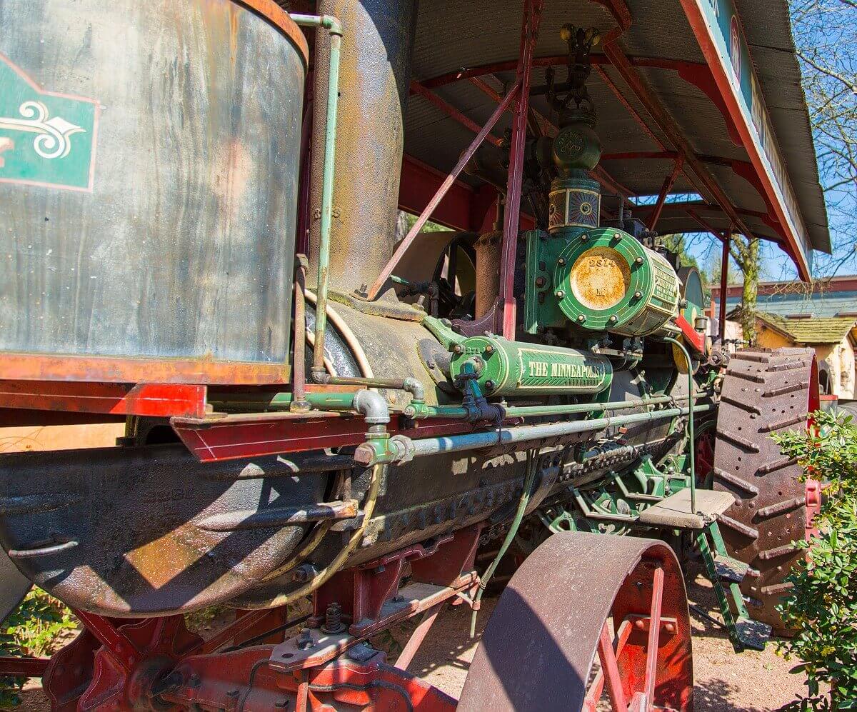 Antiques from the time of the gold diggers Lateral view of an old tractor with green painting