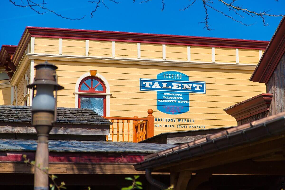 advertising board of a talent agency On the outside wall of a building in Frontierland you can see the advertisement of a talent agency