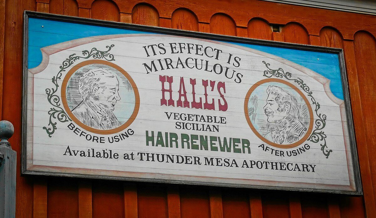 Old advertising poster On a wall in Frontierland hangs an old-looking poster advertising a miraculous hair-growth remedy