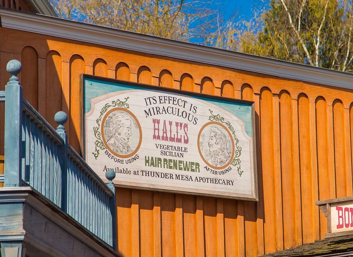 Advertising poster in Thunder Mesa On a house wall in Thunder Mesa hangs a billboard advertising a miraculous hair renewal product