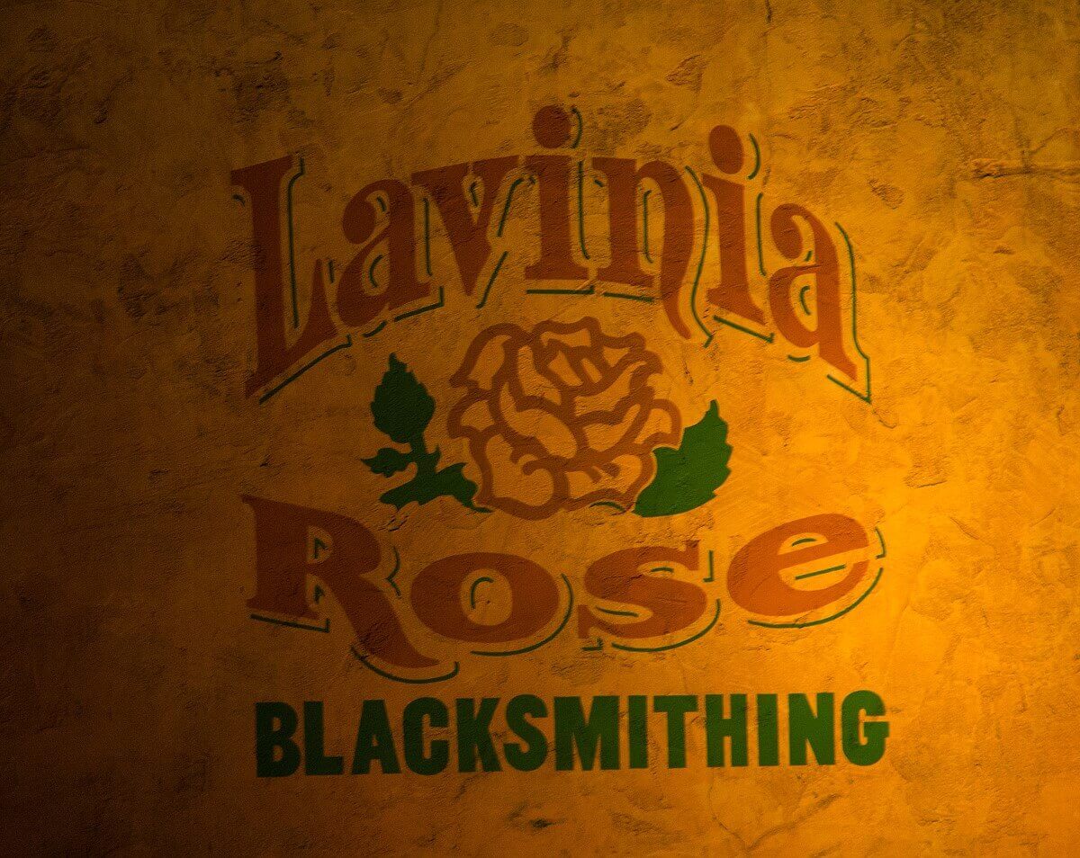 Logo of the blacksmith On a wall in Frontierland is the logo of the bottom frame Lavinia Rose Blacksmithing with a rose