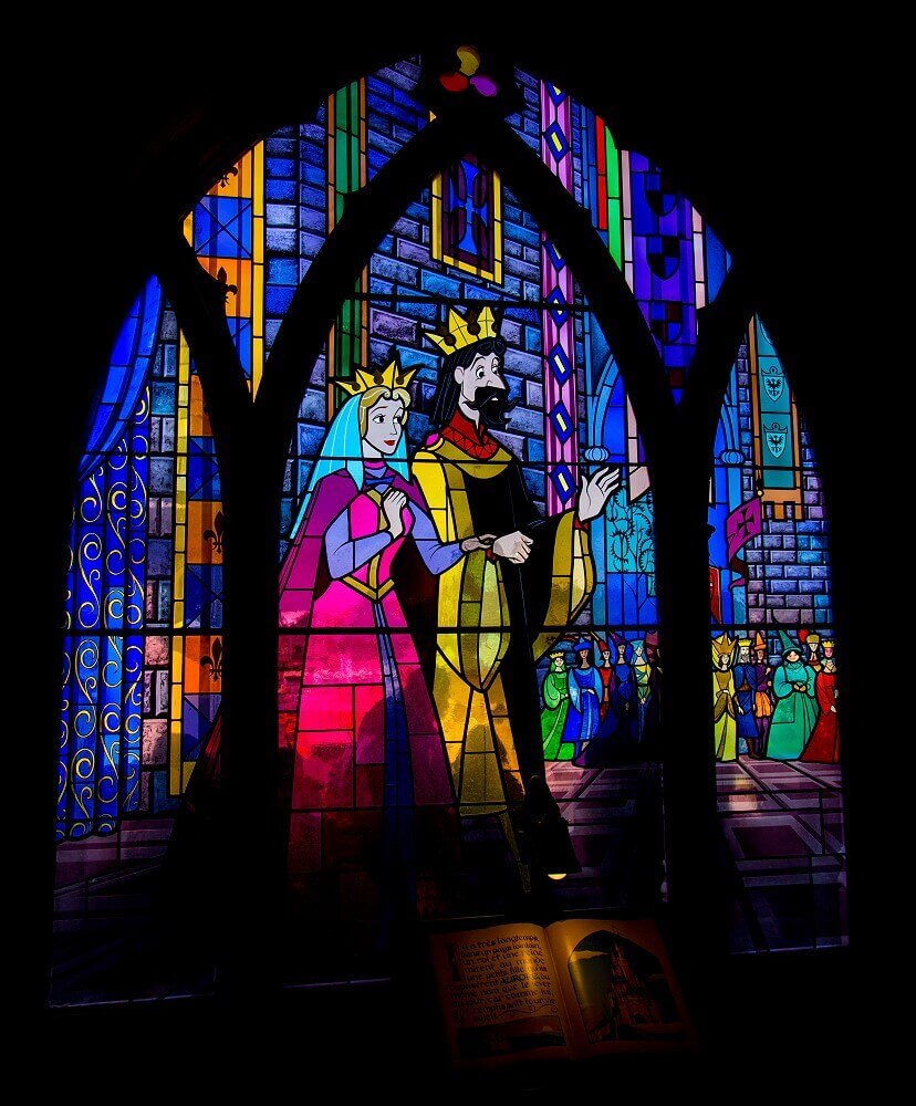 Stained glass window with king and Sleeping Beauty Tripartite stained glass window showing Sleeping Beauty with his father, the king