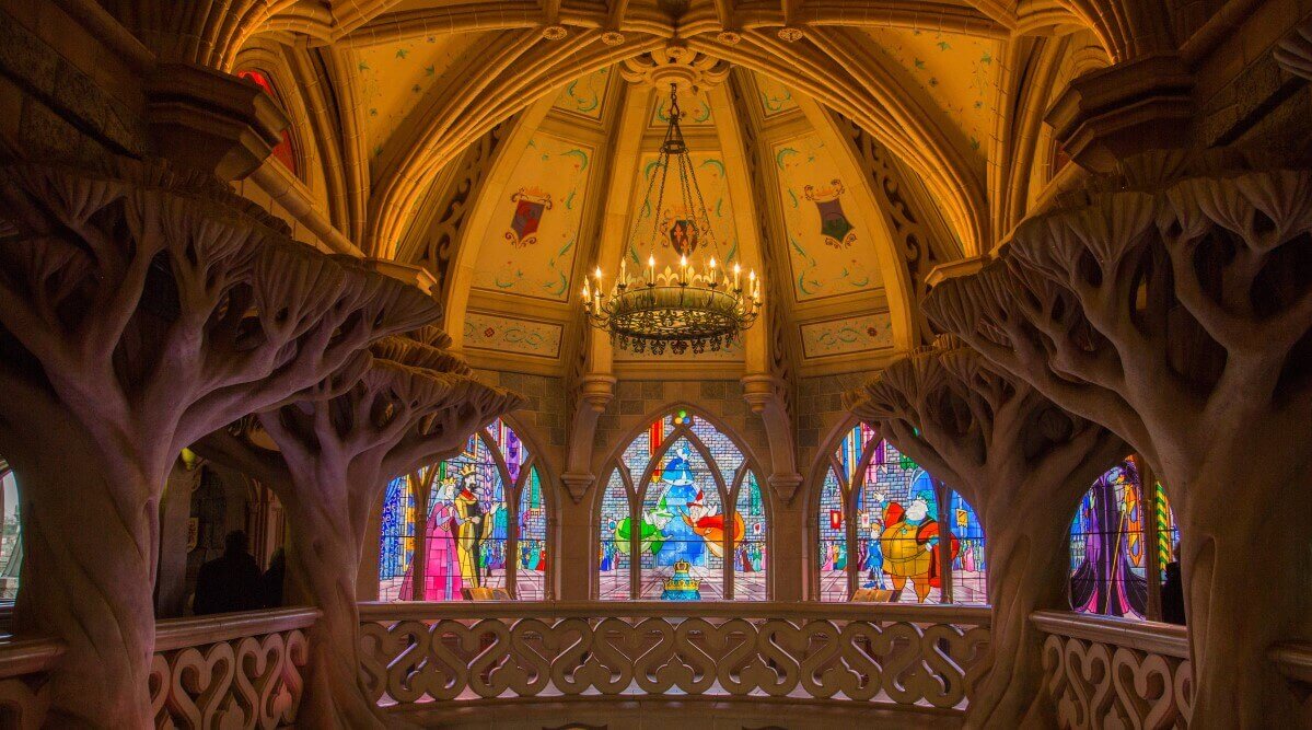 Stained glass window in the castle gallery Three magnificent stained glass windows, above a dome from which a chandelier hangs down