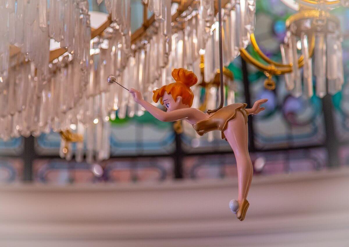 Tinkerbell in a golden dress Tinkerbell in a very skimpy gold dress flies underneath the chandelier