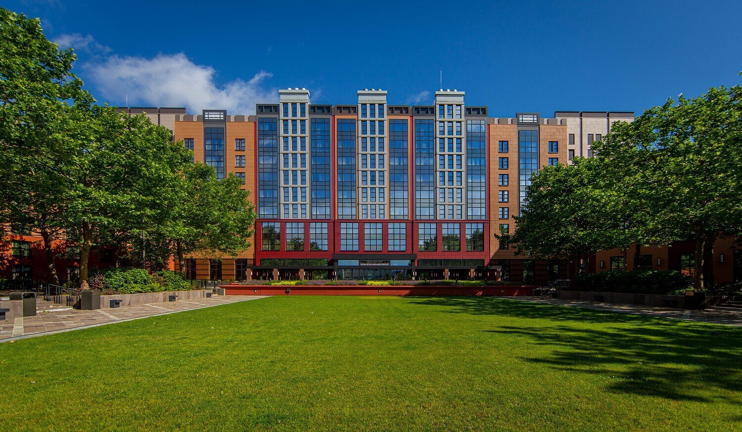 Exterior view Hotel New York The Art Of Marvel View from Lake Disney at the hotel with green pitch in the front of it.