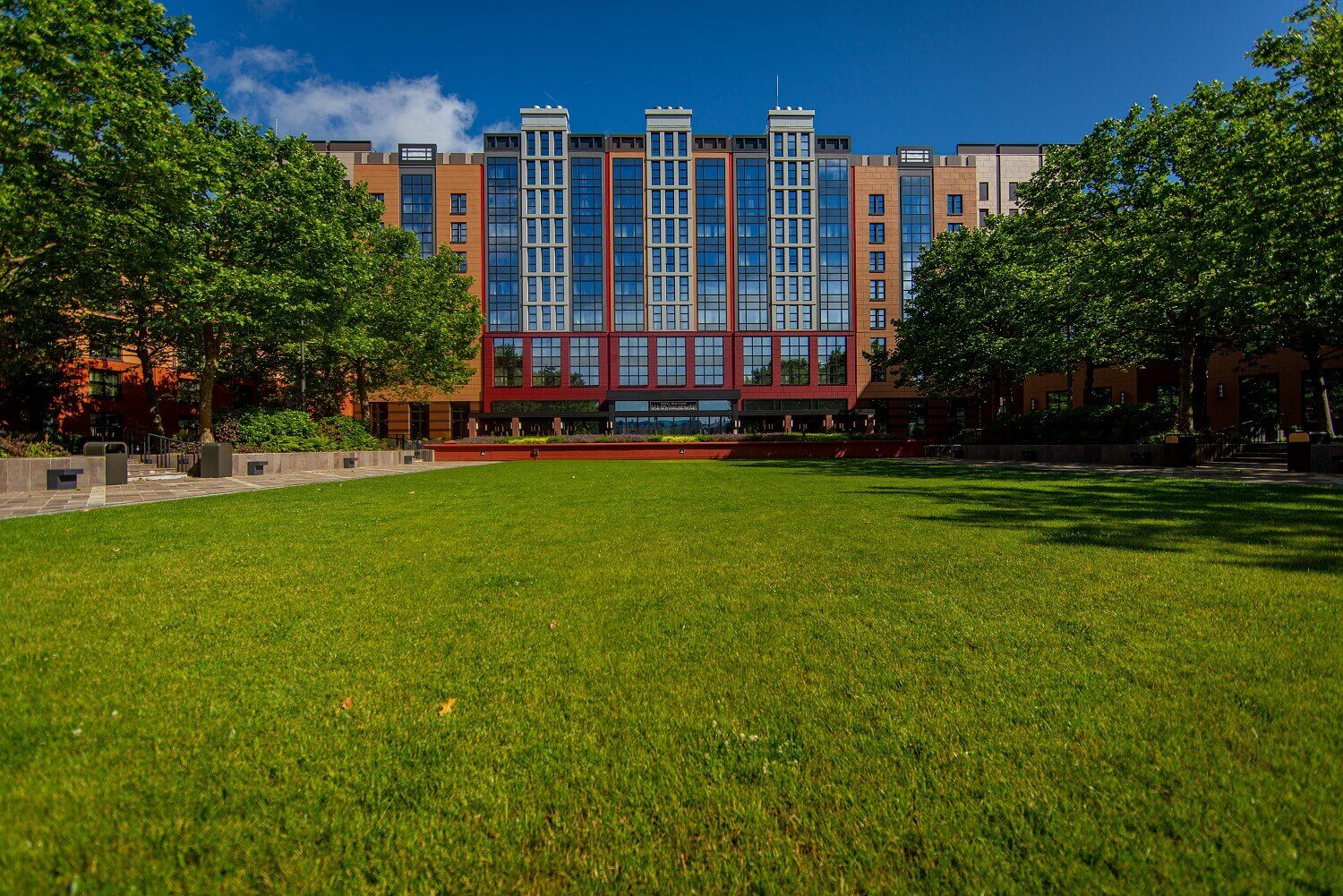 Exterior view Hotel New York The Art Of Marvel View from Lake Disney at the hotel with green pitch in the front of it.