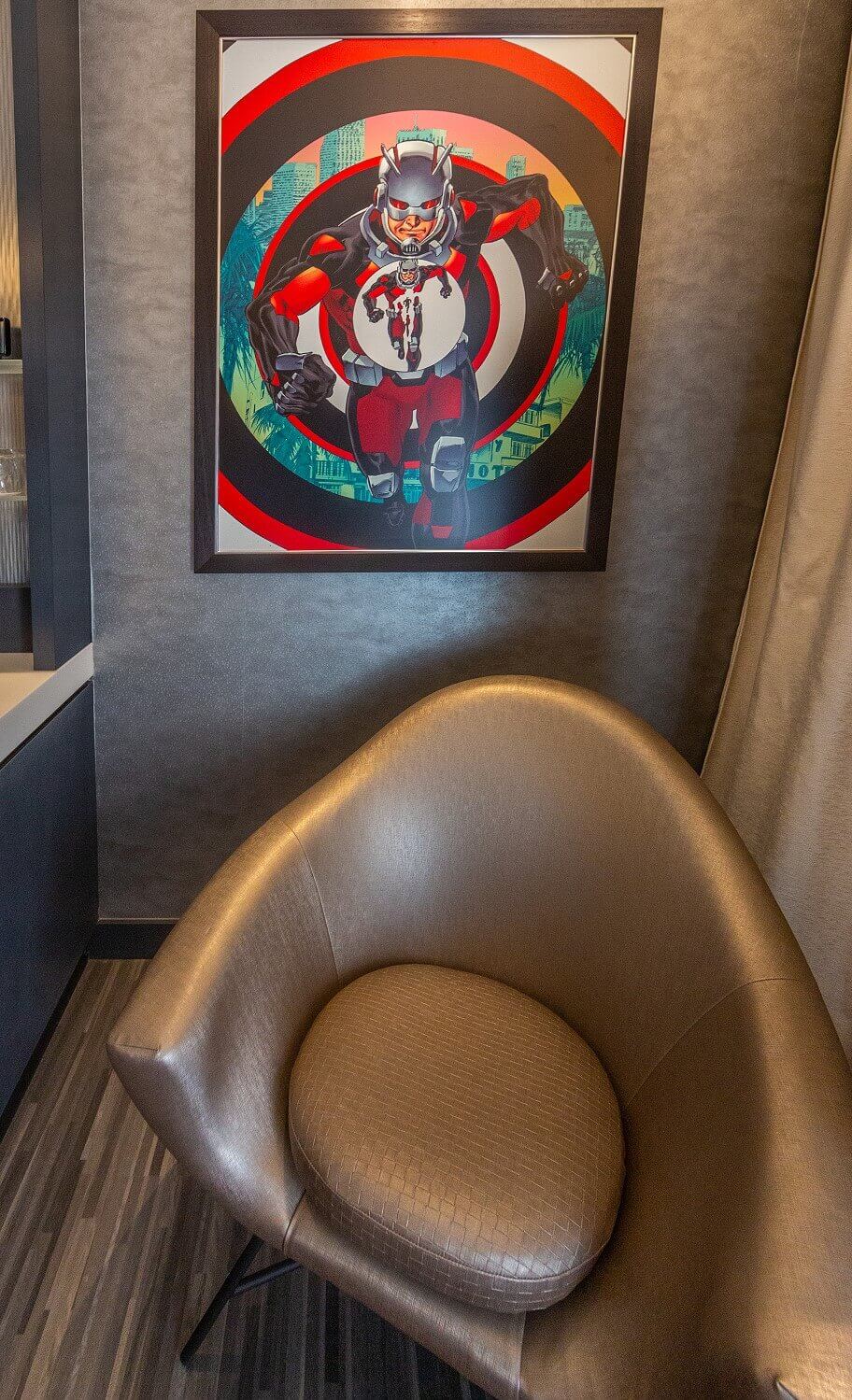 Empire State Room A picture hangs over a gray armchair